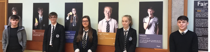 Young people in front of their own photos at Elphinstone Institute.
