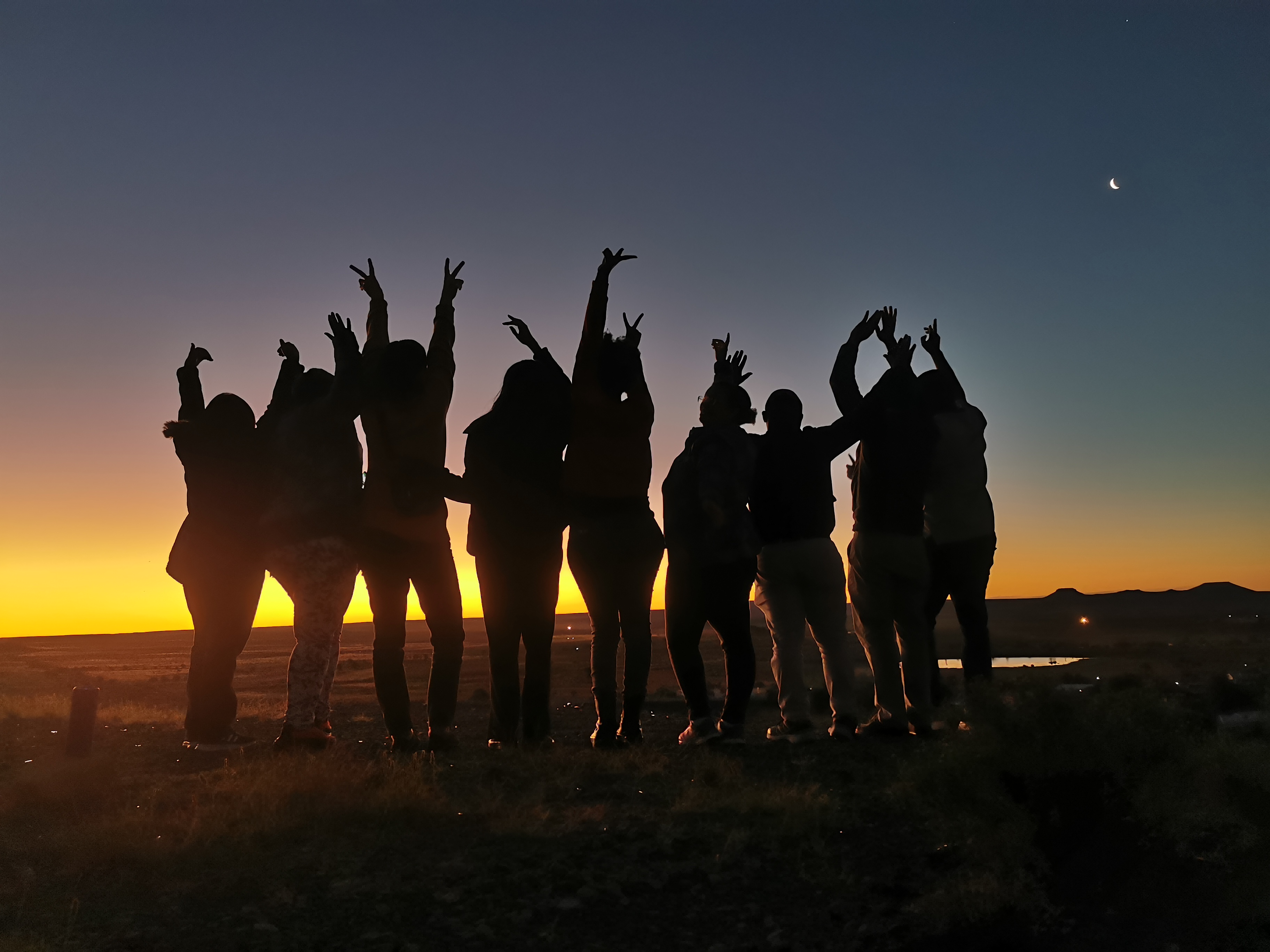 An image of a group of people watching the sunset in the remote town of Carnarvon, Northern Cape South Africa. 