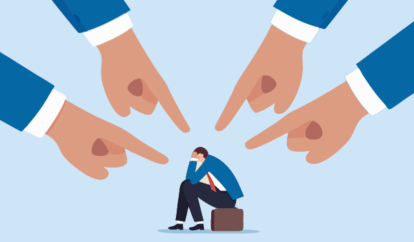 An illustration showing a person sitting on a small suitcase with their head resting on one hand, surrounded by four large hands pointing toward them from different directions.