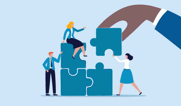 An illustration of three people assembling large puzzle pieces together, while a giant hand places an additional puzzle piece in place.