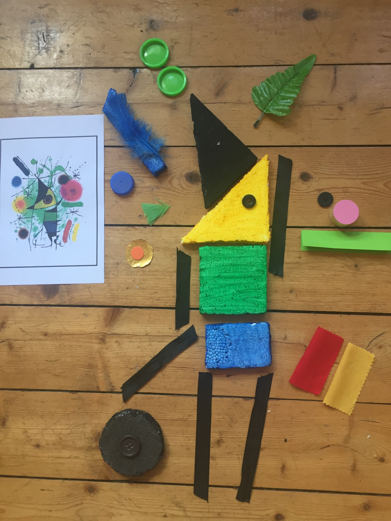 Table top showing Joan Miro’s ‘The Singing Fish’ alongside a copy using craft items