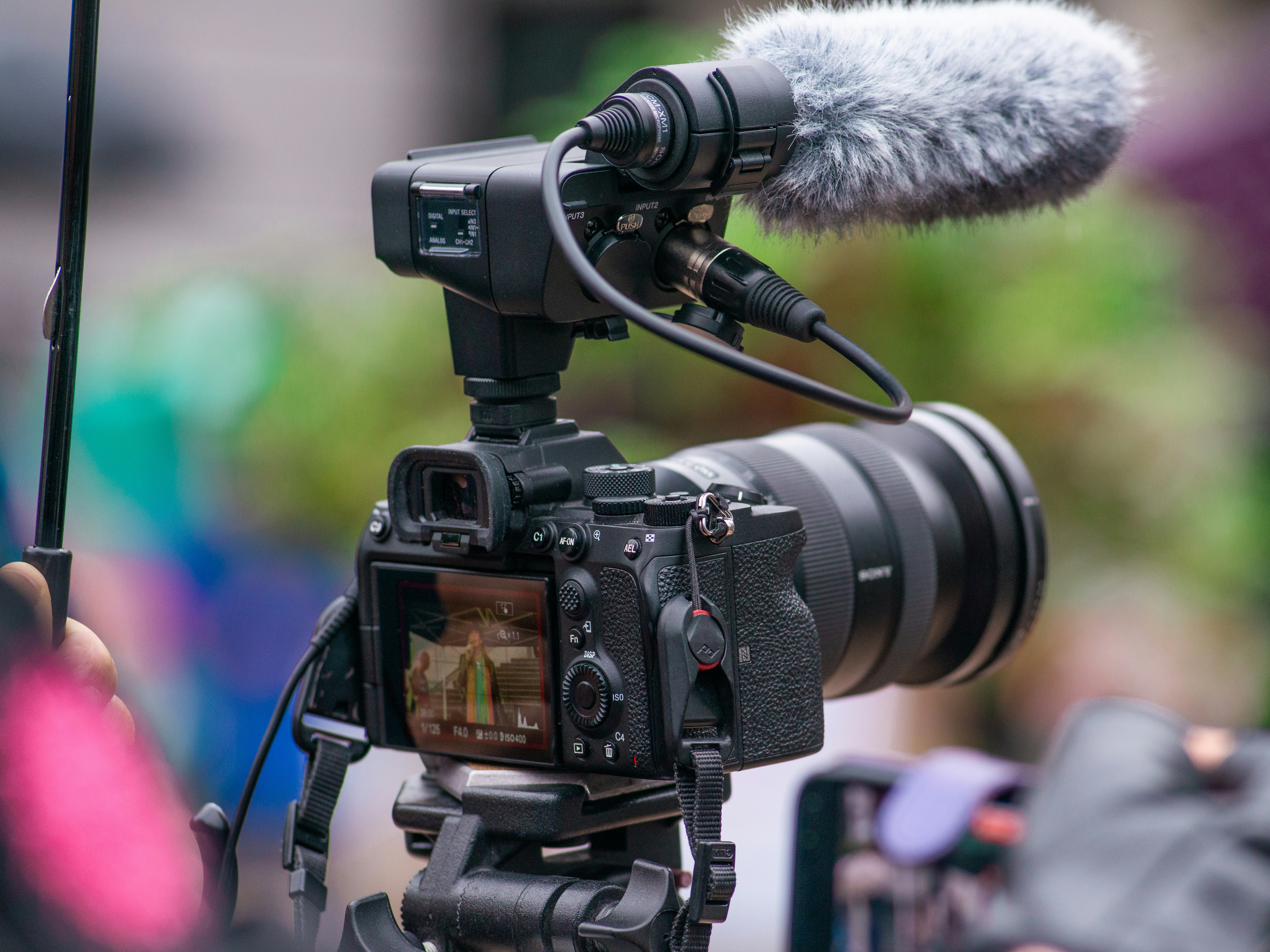 A digital camera with a microphone recording a live event