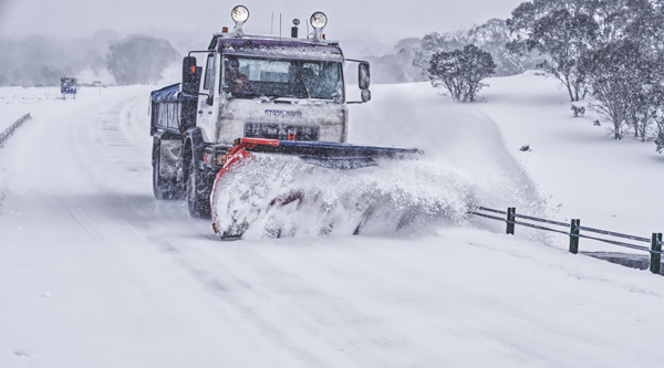 A photo of a snow plough clearing a road.