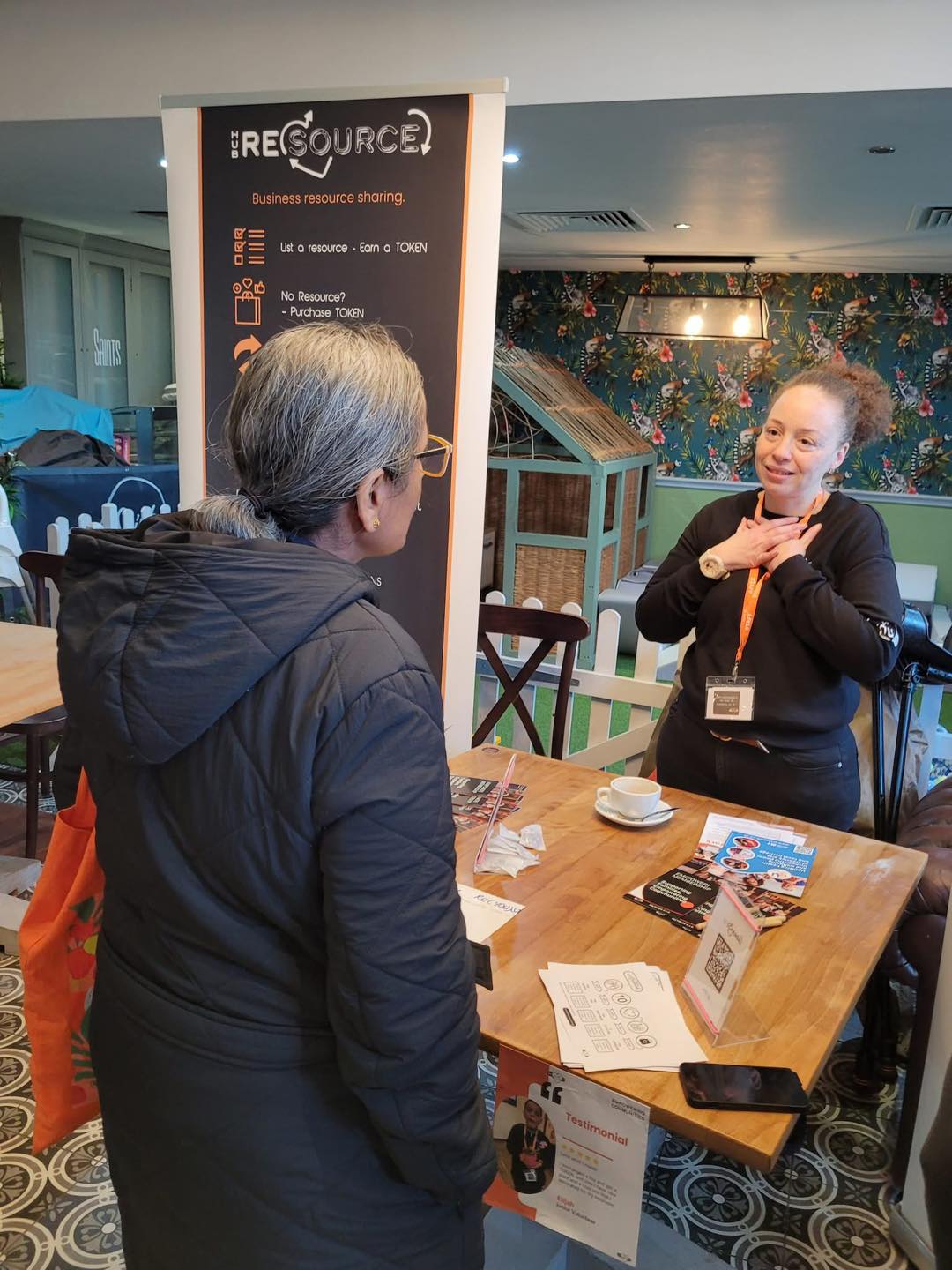 A student entrepreneur speaking with someone about their business. 