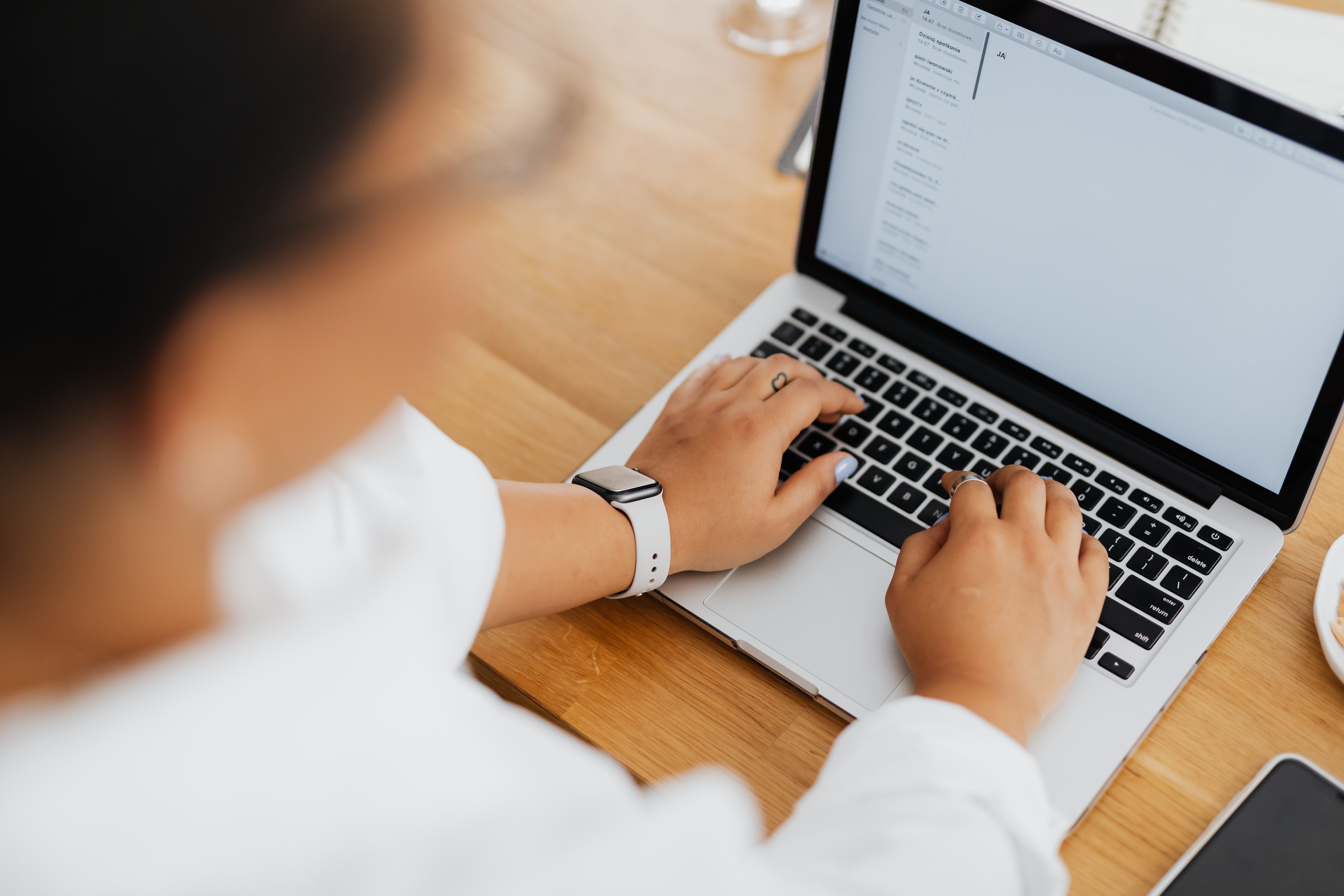Hands on a laptop away to send an email